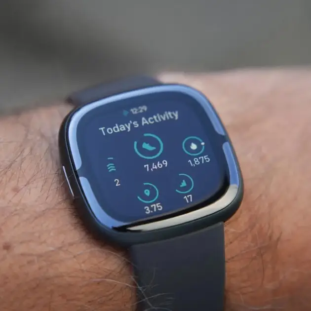 Fitbit Sense 2 smartwatch displaying health and smart features on its screen.