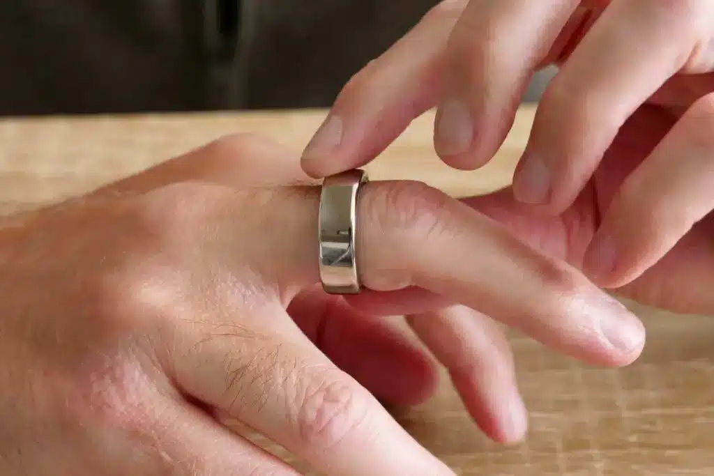 Sleek Oura Ring Gen 3 resting on a finger, highlighting its minimalist design and lightweight comfort.