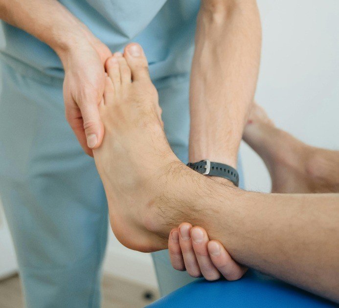 Hand applying acupressure to relieve foot pain