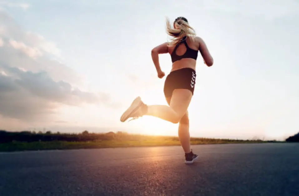 Runner sprinting at sunrise, symbolizing boosted cardio fitness