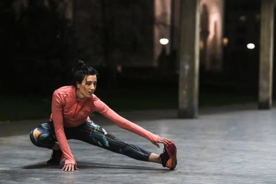 Person stretching before a cardio workout, emphasizing pre-workout warmup for better results.
