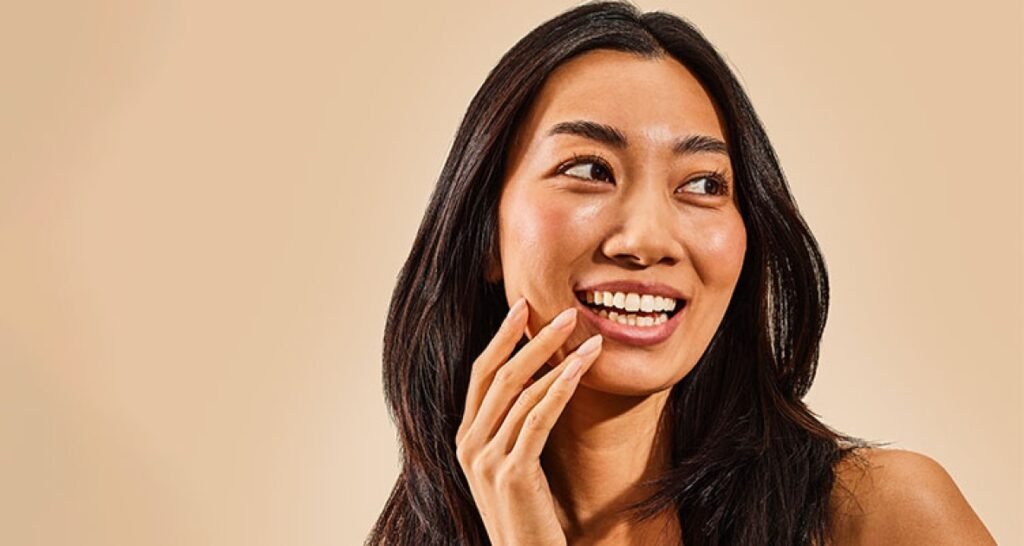 Smiling collagen peptides user with glowing skin