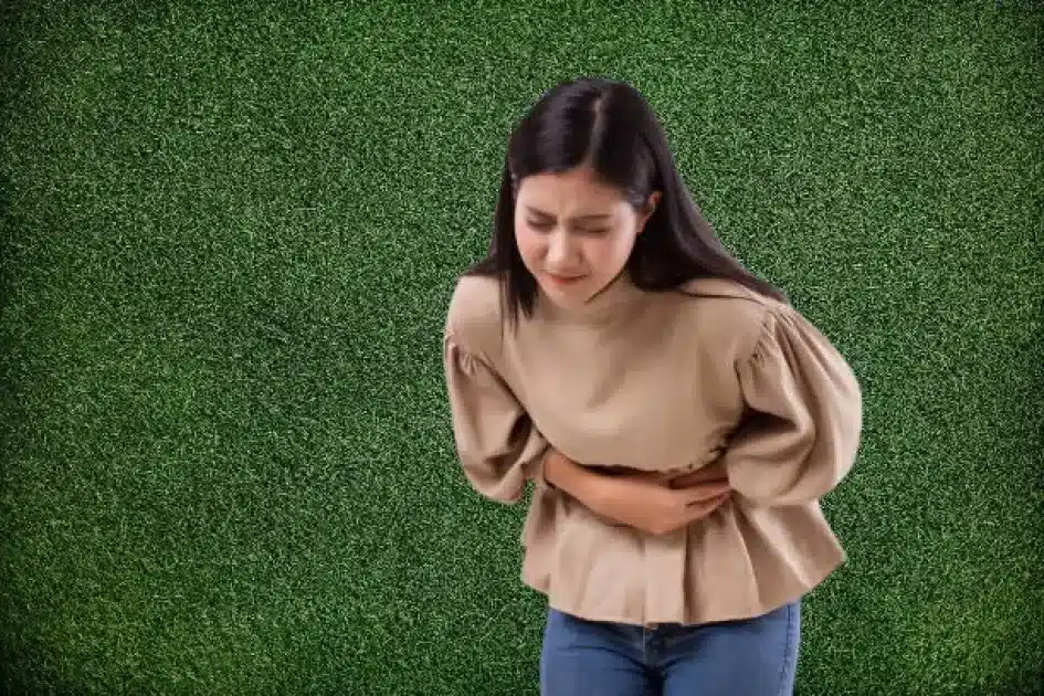 Person clutching stomach in discomfort, symbolizing health risks of the ketogenic diet.