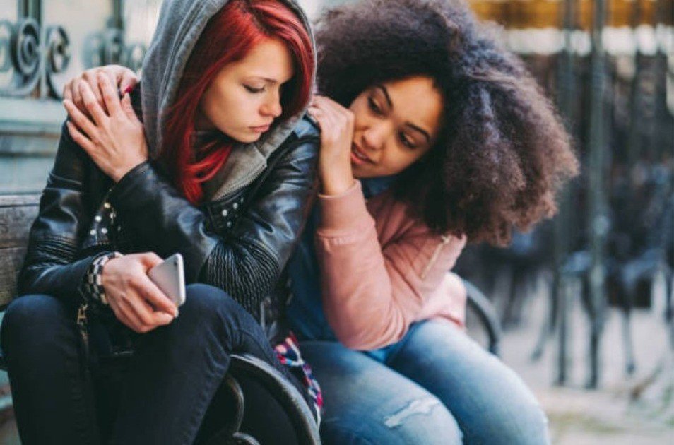 Person feeling overwhelmed while scrolling social media, symbolizing the emotional toll of online comparison.