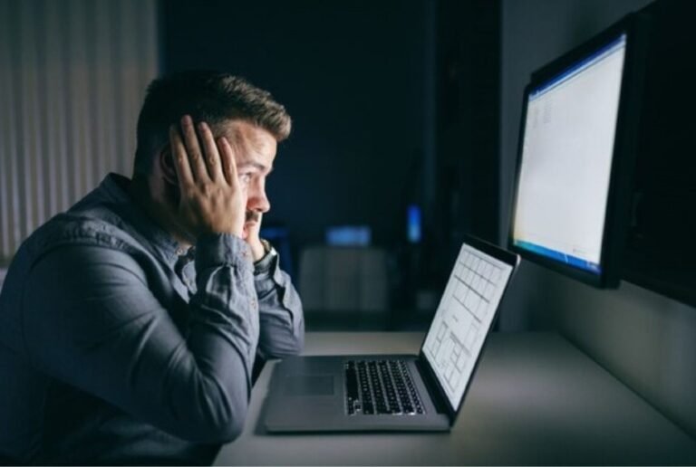 Person overwhelmed by screens, symbolizing the mental toll of unhealthy digital habits