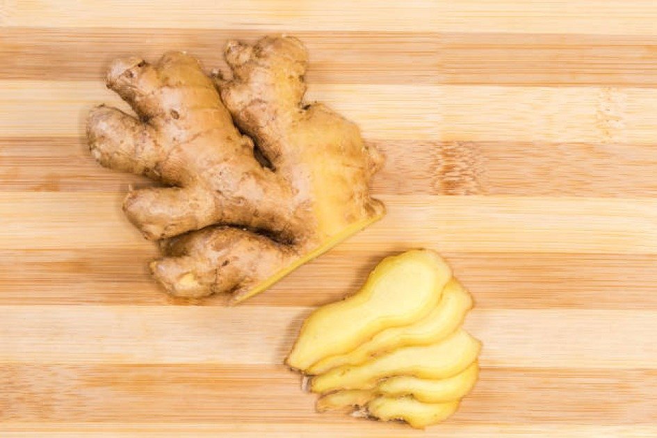 Fresh ginger root sliced on a wooden board, symbolizing its immune-boosting properties.
