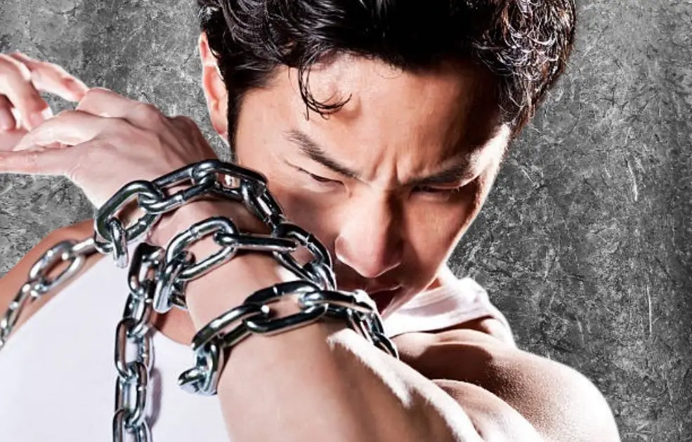 Silhouetted figure gripping a heavy chain, surrounded by storm clouds, symbolizing emotional burden and unresolved anger.