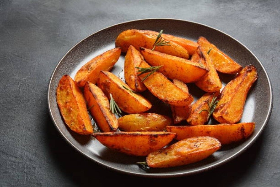 Roasted sweet potatoes on a plate, symbolizing healthy eating during intermittent fasting.