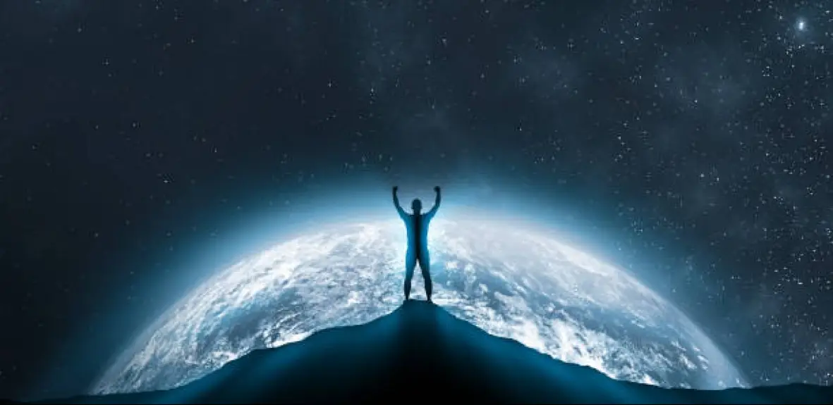 Person standing strong atop a dark, rocky mountain symbolizing triumph over mental health challenges.