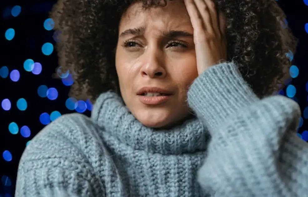 A person surrounded by spiraling, dark thought bubbles representing negative self-talk and intrusive thoughts.