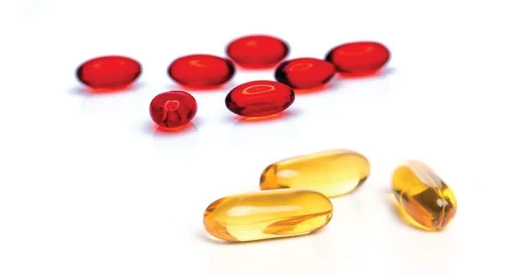 Close-up of omega-3 fish oil capsules beside other supplement pills for comparison