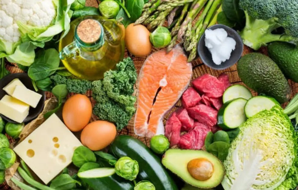 A plate of meat and greens under a spotlight, surrounded by shadowed missing food groups like grains and legumes.