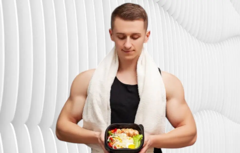 Athlete replenishing with a nutritious meal post-workout, symbolizing recovery and strength.