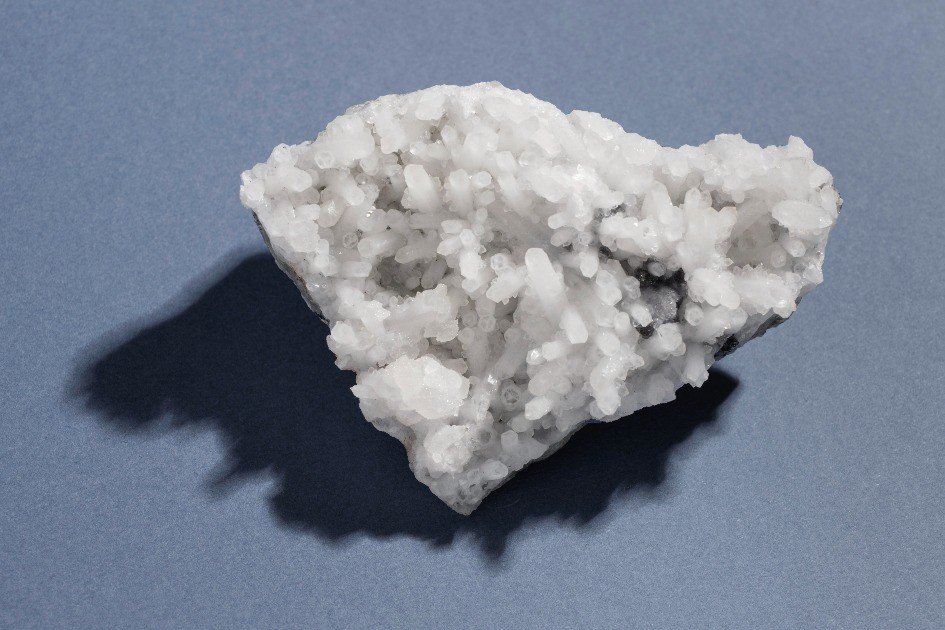 Selenite crystal radiating calming, high-vibrational energy on a natural surface