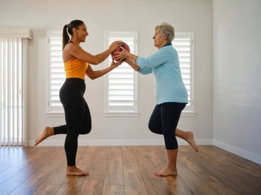 Active senior stretching outdoors to promote flexibility and mobility.