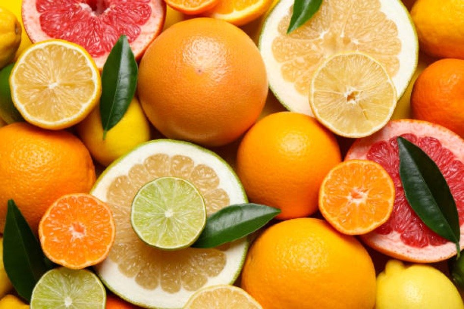 Assorted citrus fruits including oranges, lemons, and grapefruits sliced and whole, symbolizing immune-boosting nutrition.