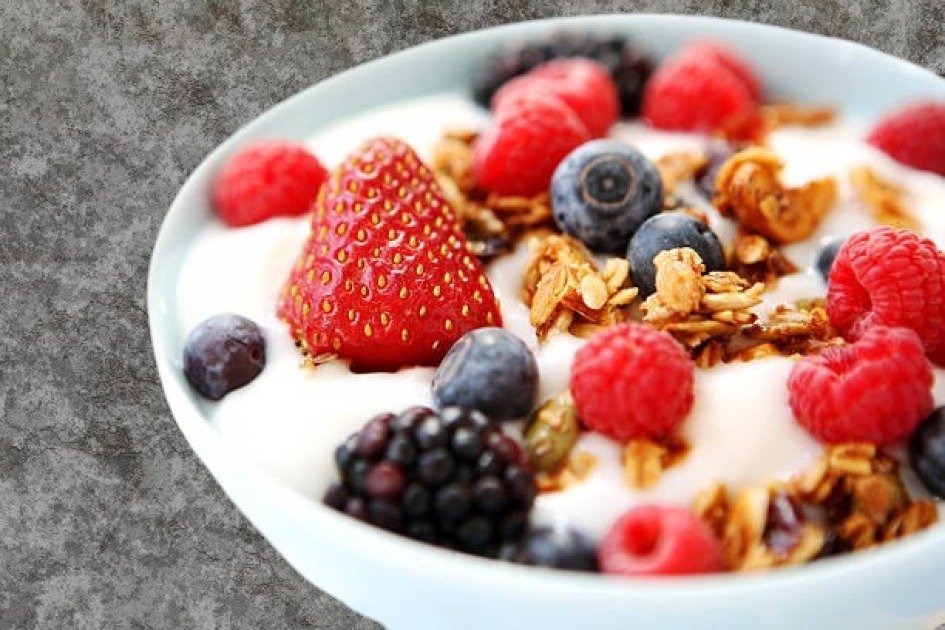 Bowl of creamy yogurt topped with fresh berries and seeds, symbolizing immune-boosting nutrition.