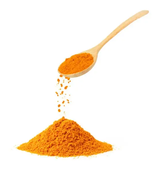 Vibrant turmeric powder spilling from a wooden spoon, symbolizing vitality and health