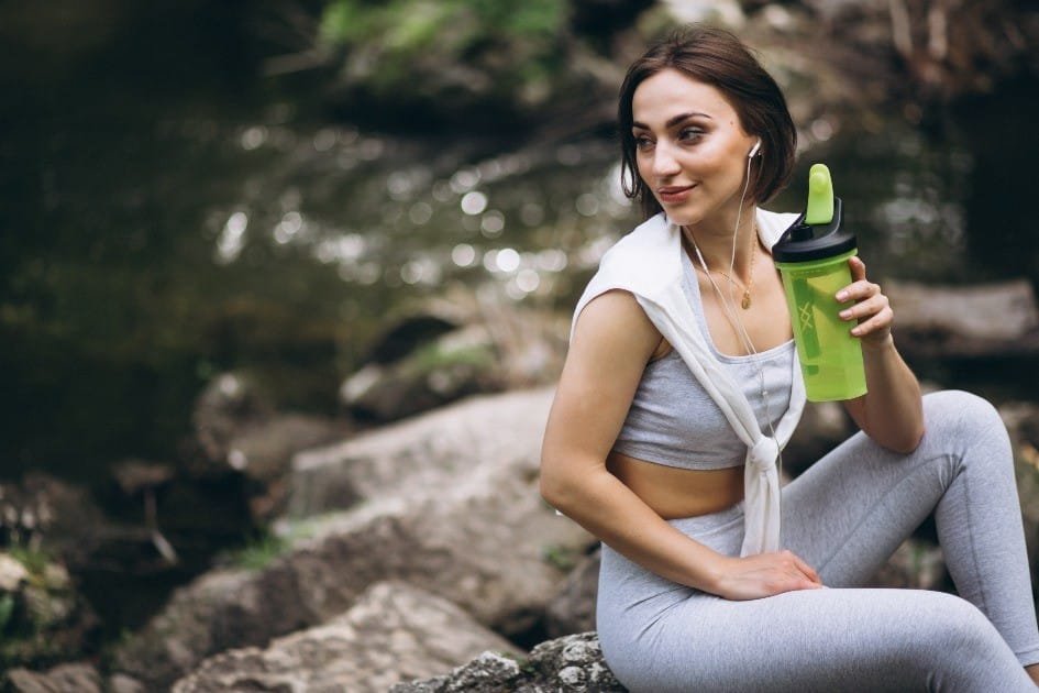 A person drinking powerful supplements that skyrocket energy, vitality, and wellness.