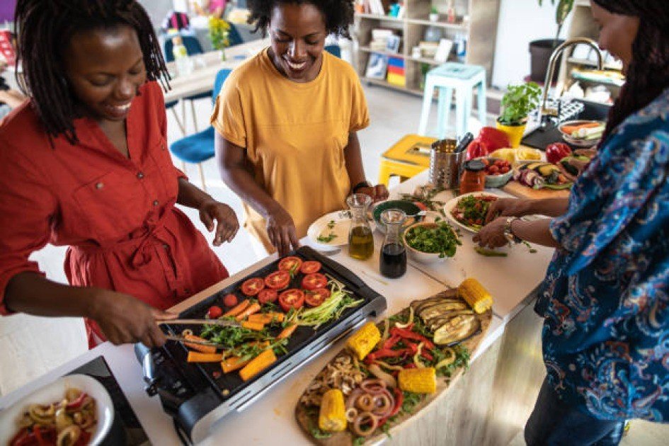 Vibrant assortment of vegetarian foods with energetic person in background