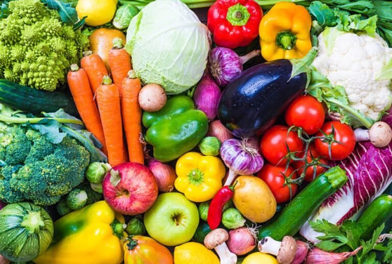 Colorful assortment of fresh vegetables and fruits symbolizing the benefits of a vegetarian diet.