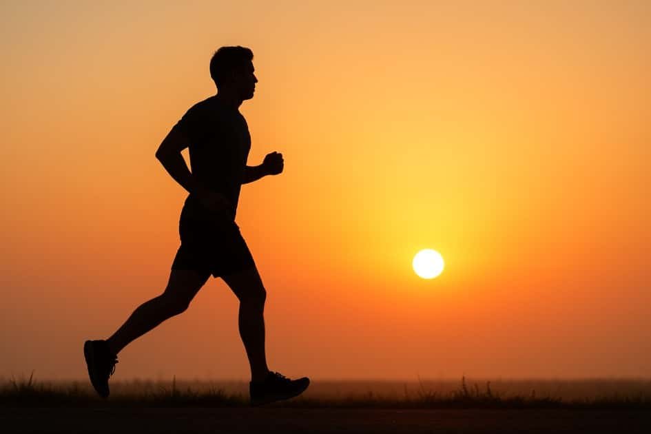 Person jogging at sunrise showing heart health and energy benefits of cardio fitness