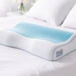 Technogel Contour Pillow on a bed, showing ergonomic design for neck and head support.