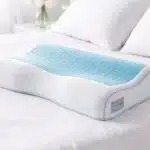 Technogel Contour Pillow on a bed, showing ergonomic design for neck and head support.