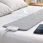 Withings Sleep Tracking Mat on a bedroom mattress monitoring sleep patterns