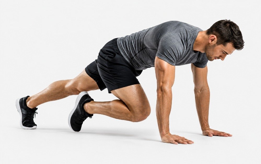 Person performing mountain climbers for fast-paced core strength and cardio conditioning.